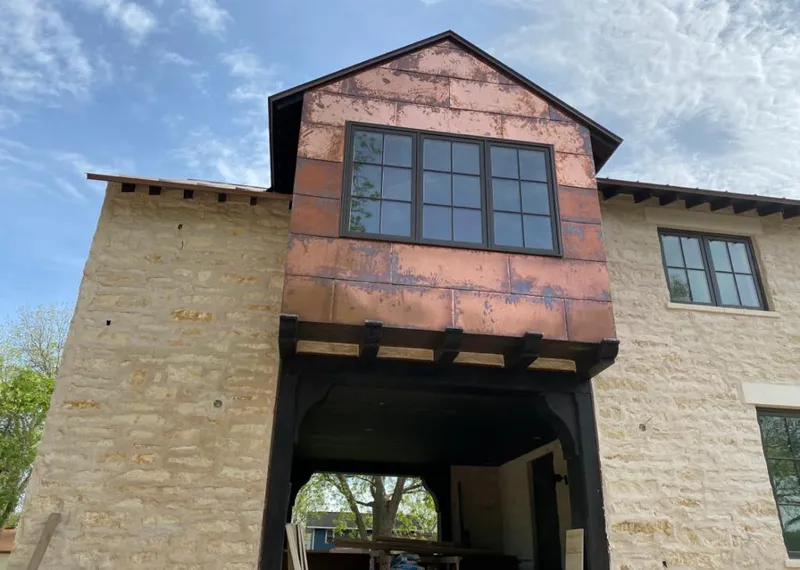 Copper metal panel facade on a stone building for Metal Roof Coating in Englewood