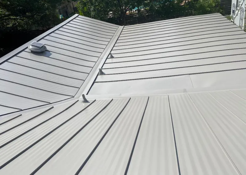 Solar attic fan installed on a metal roof for Roof Ventilation in Englewood